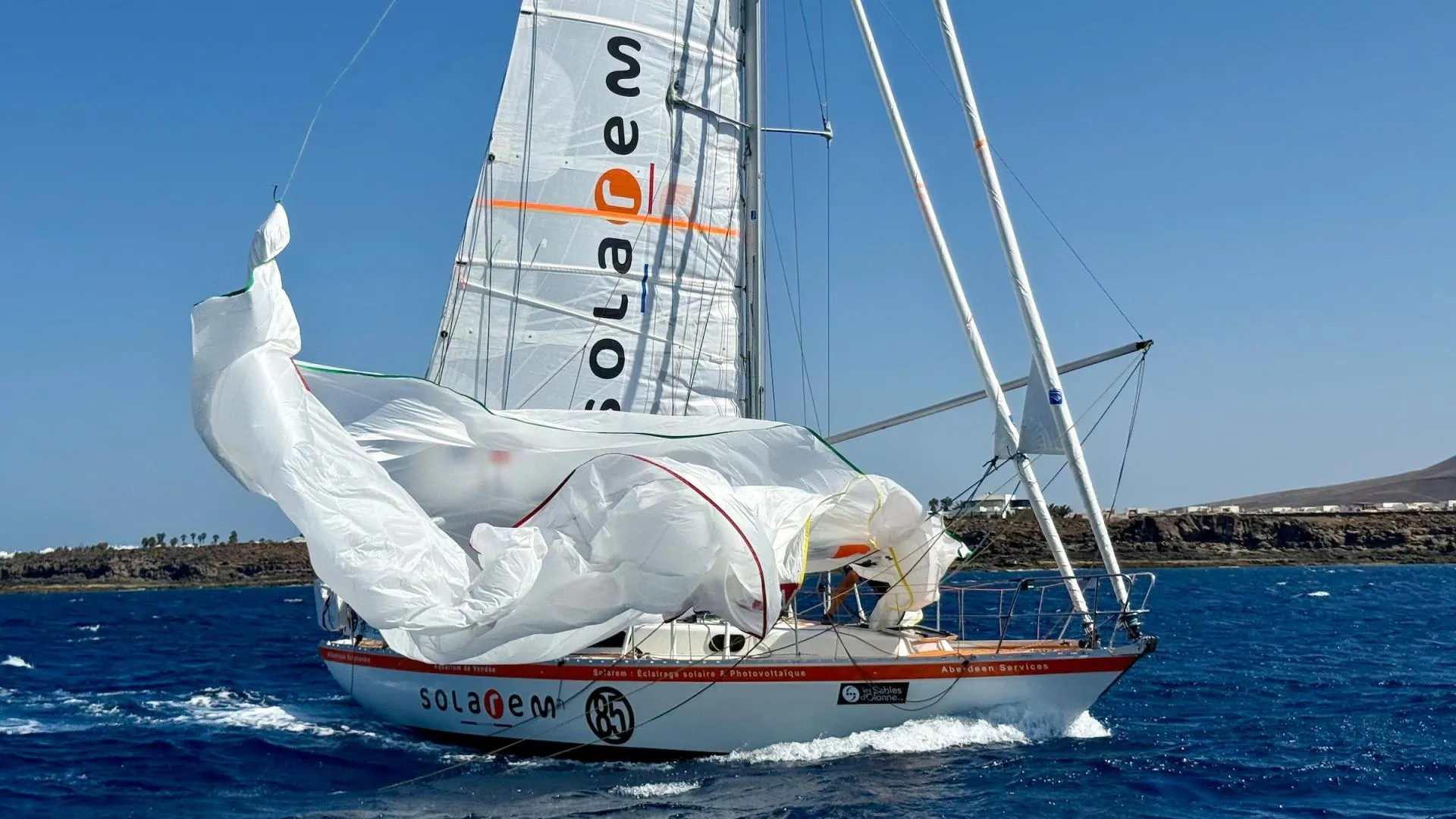 A spectacular sail change for the race leader. Guillou brings down spinnaker aboard Rustler 36 SOLAREM during the Lanzarote film drop. French skipper reached Marina Rubicón first, before anchoring to complete an unaided masthead repair & continuing south